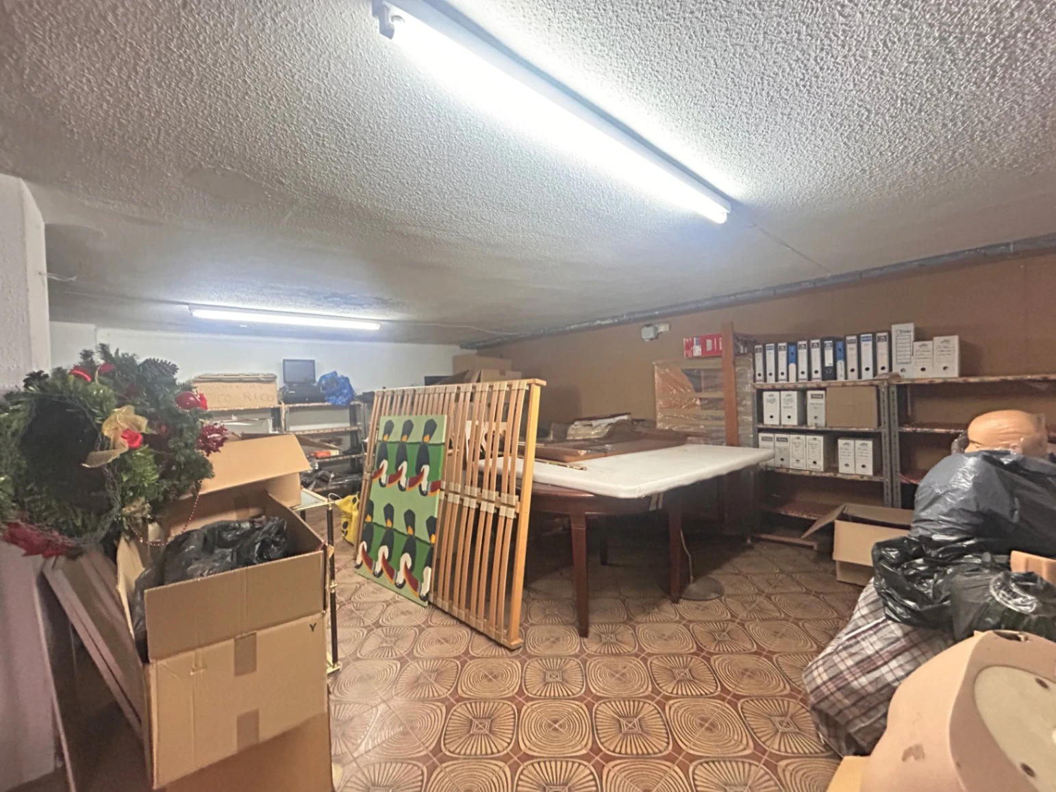 Commercial premises with a large storage area and shop at street level.