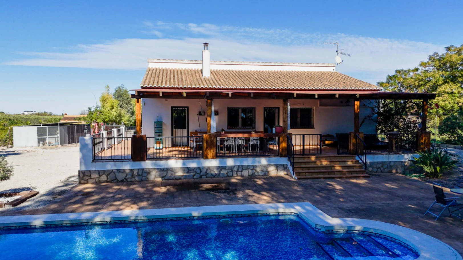 Large rustic estate comprising two houses and stables for horses.
