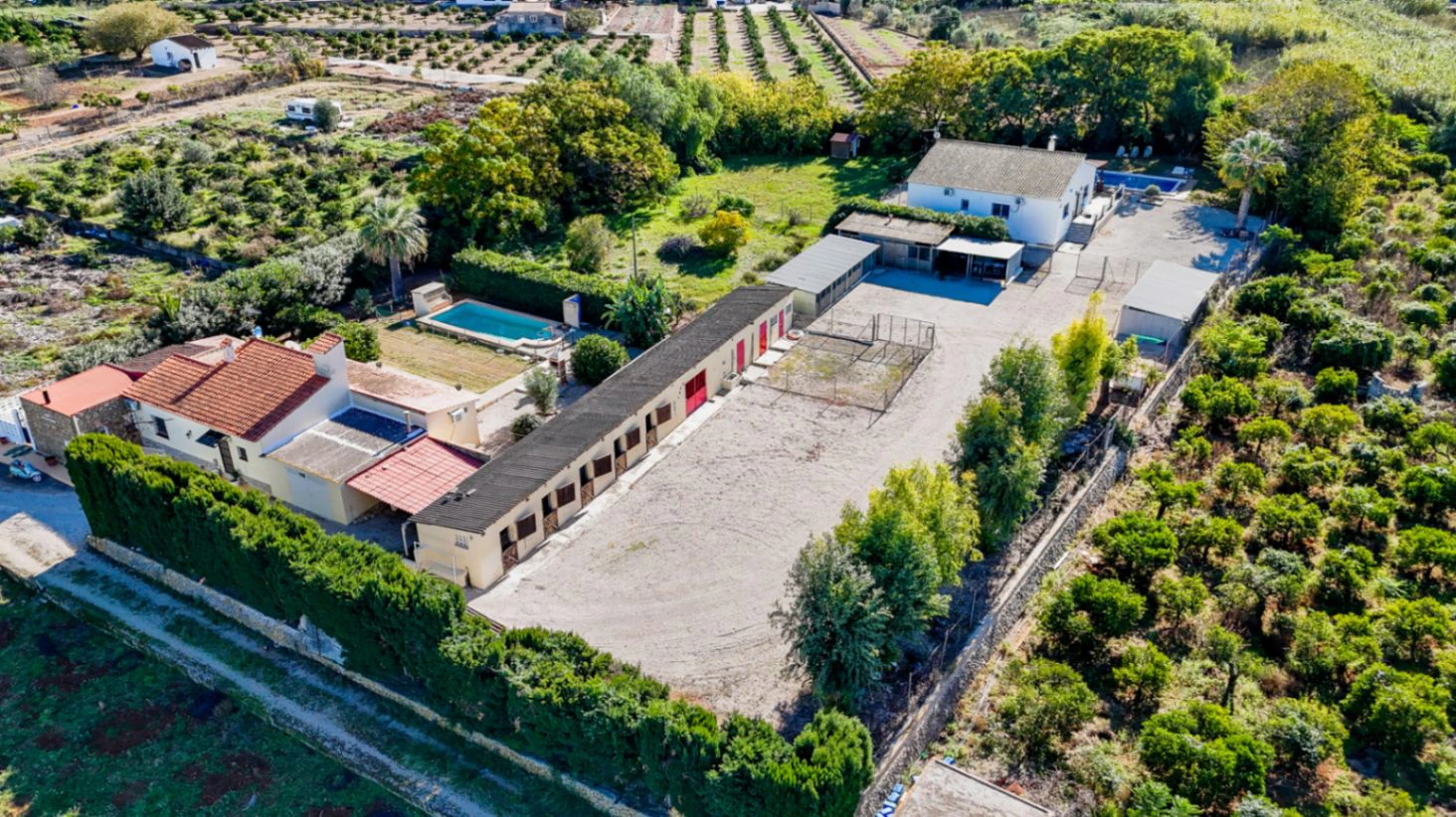 Large rustic estate comprising two houses and stables for horses.