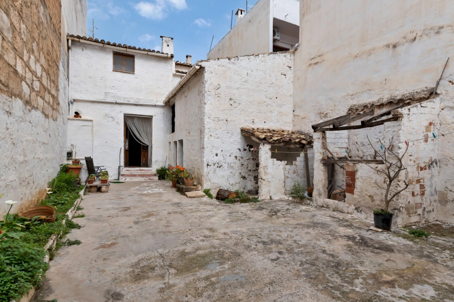 Village house with garage, spacious inner courtyard, and potential to expand the property.