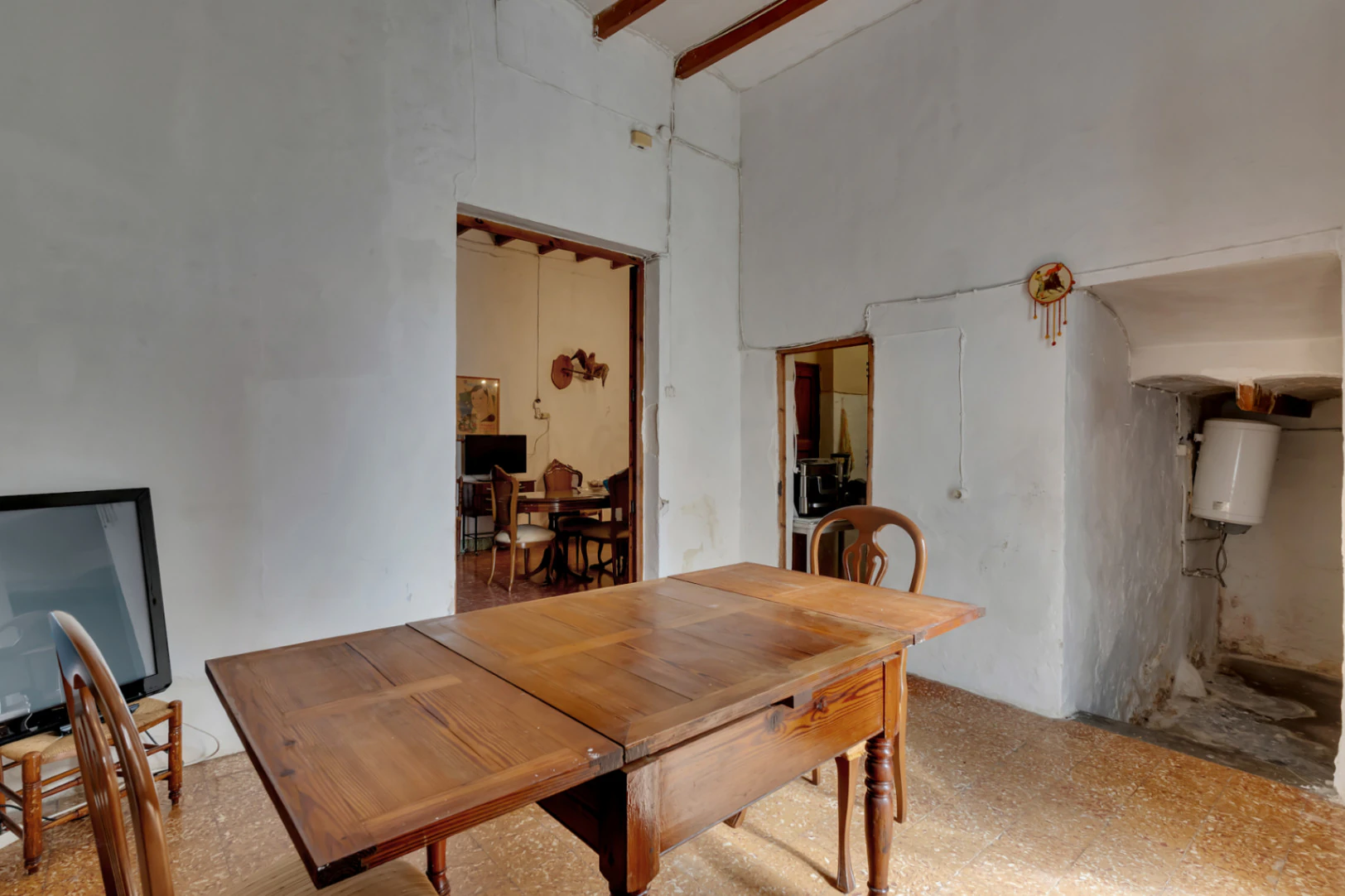 Village house with garage, spacious inner courtyard, and potential to expand the property.