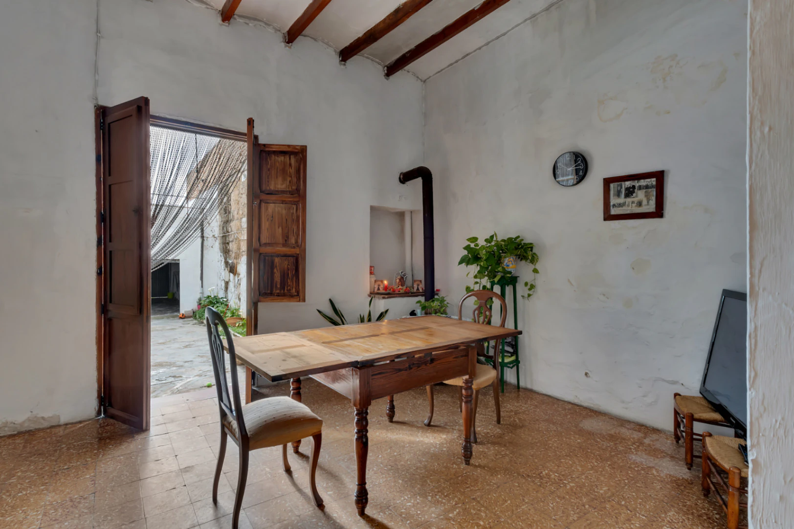 Village house with garage, spacious inner courtyard, and potential to expand the property.