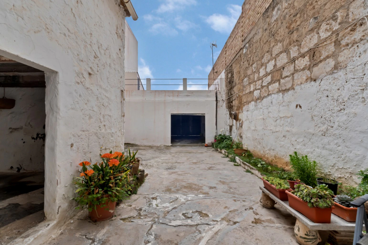 Village house with garage, spacious inner courtyard, and potential to expand the property.