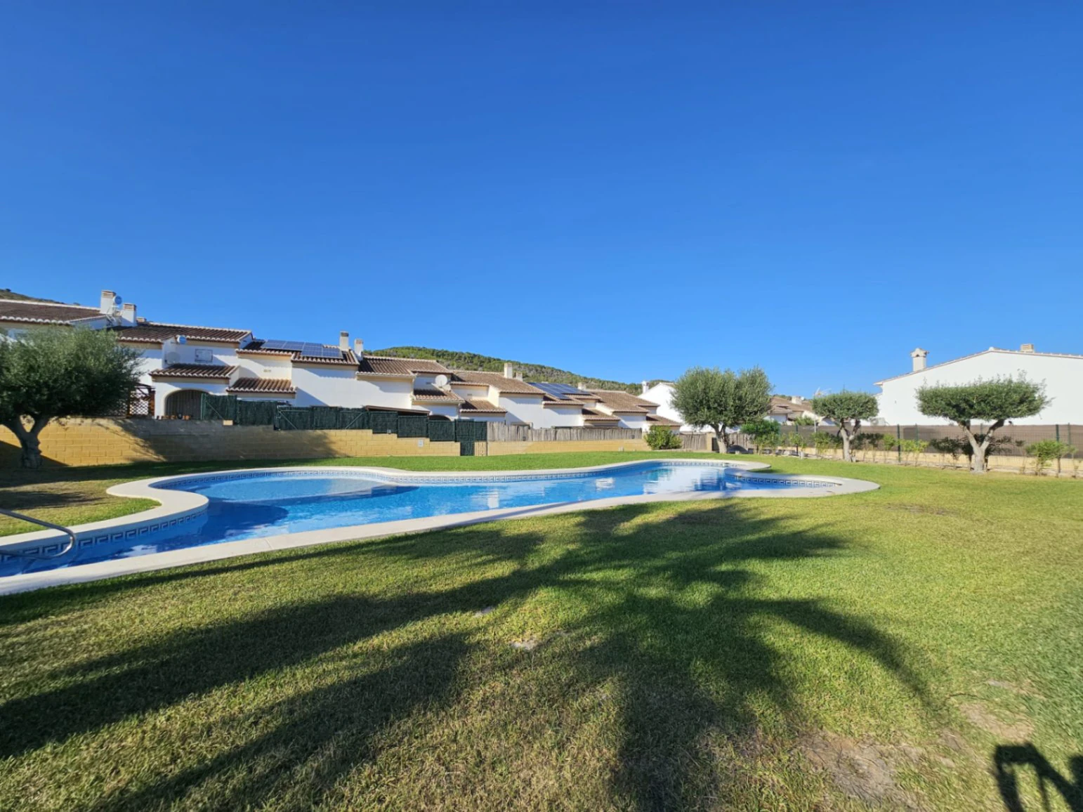 Casa adosada en venta en Benitachell con 2 dormitorios y piscina comunitaria.